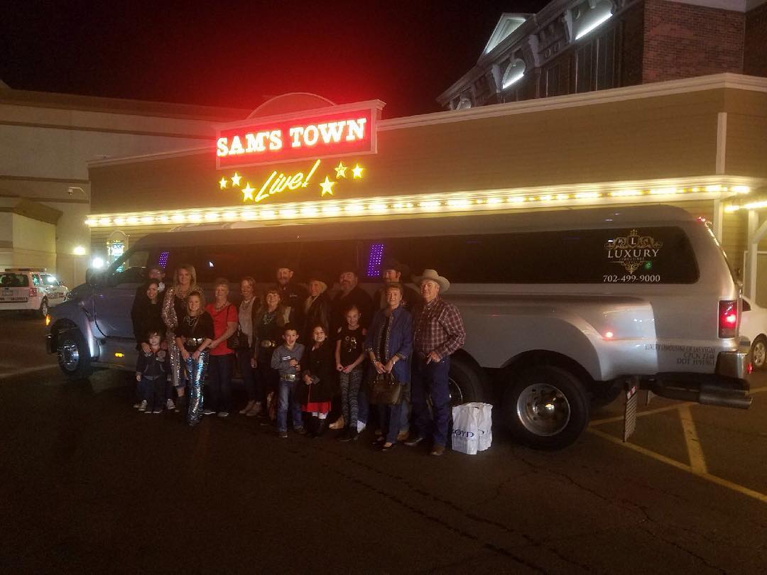 Multi-generational group posing outside large party bus at Sam's Town casino Las Vegas family event
