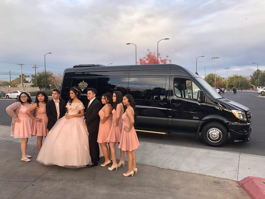 Quinceañera young woman in blush pink ball gown posed in front of Mercedes Sprinter Las Vegas