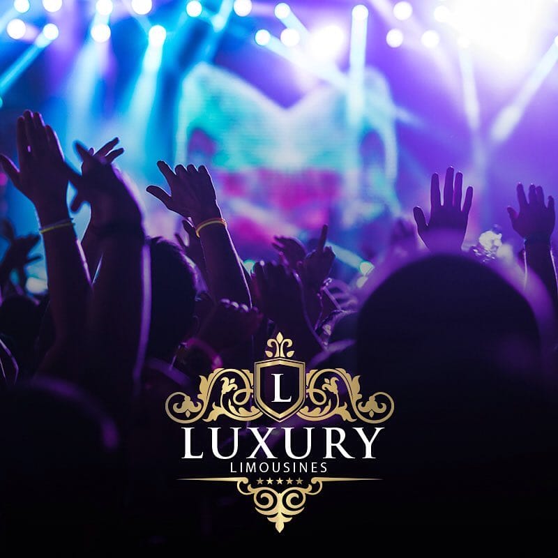 Concert crowd with raised hands under purple and blue stage lights Las Vegas event limo transportation