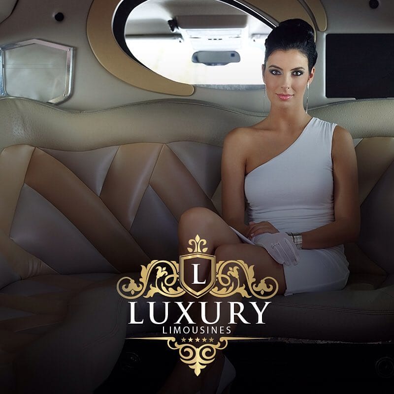 Young woman in white dress seated inside luxury stretch limousine with sunroof Las Vegas prom