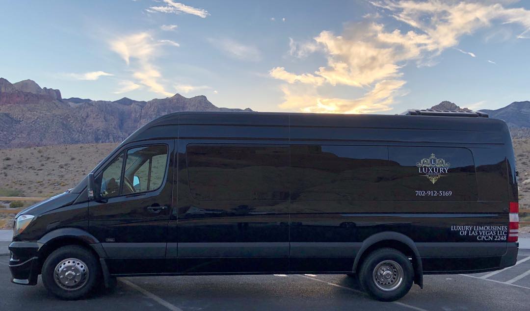 Luxury Mercedes Sprinter parked at Red Rock Canyon National Conservation Area escarpment at sunset Las Vegas private tour